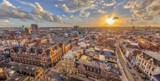 Helicopter View over historic part of Groningen city under setting sun
